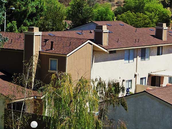 new asphalt roof shingle installations at apartment buildings