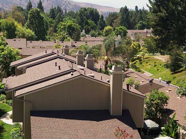 multiple new asphalt roof shingle installations in neighborhood