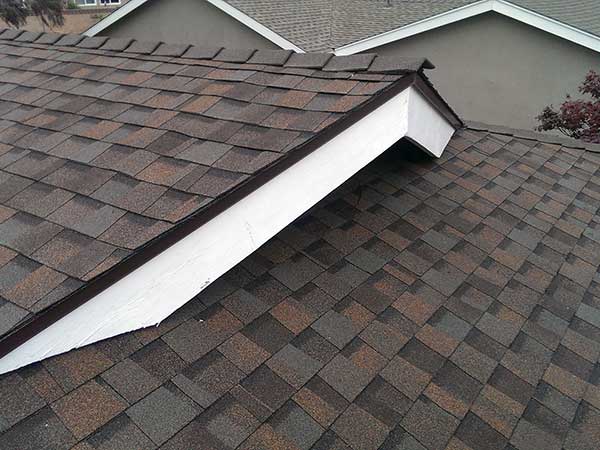 new asphalt roof shingle installation over ridge
